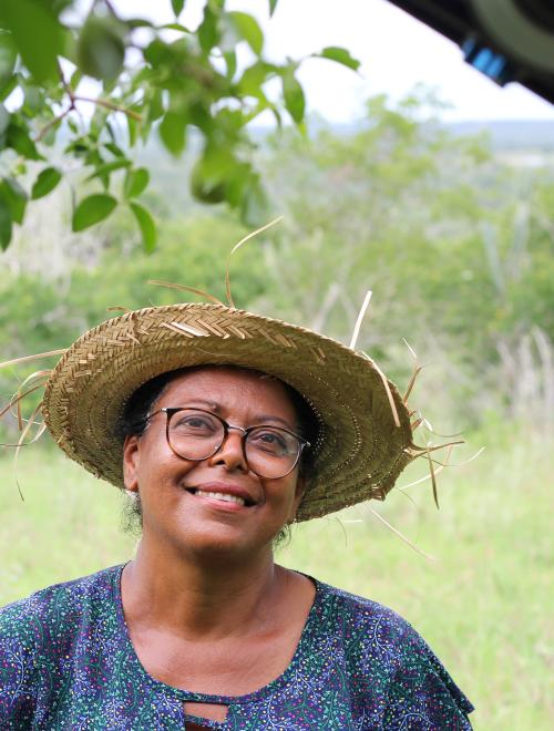 Brazilian farmer stand in field with straw hat.