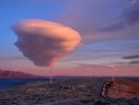 Cloud in sky above wind turbines.