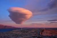 Cloud in sky above wind turbines.
