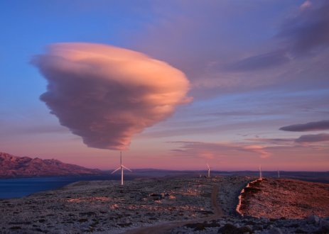 Cloud in sky above wind turbines.