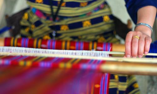 Woman weaving beautiful textile 