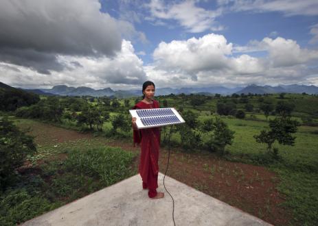 Girl stands with solar panel