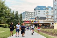 People walk along a paved walkway along the Atlanta Beltline.