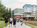 People walk along a paved walkway along the Atlanta Beltline.