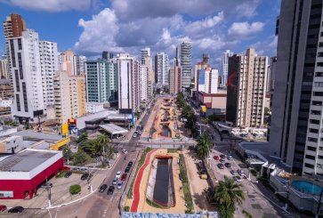 Aerial view of a city boulevard lined by skyscrapers.