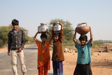 Kids carrying water in the Indian countryside. Photo by Mr. Fink/Flickr