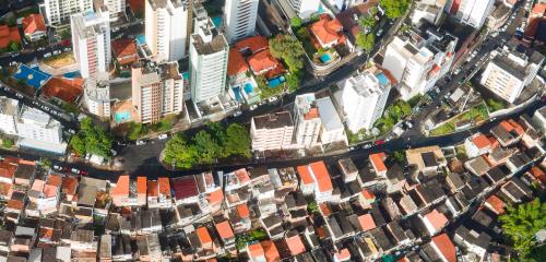 Aerial view of disparity between city and congested housing developments.