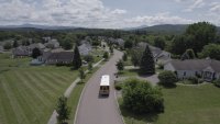 School bus driving in neighborhood.