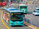 An electric bus drives down a street.