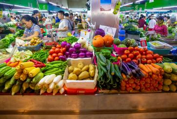Colorful vegetables are displayed in a Chinese market.