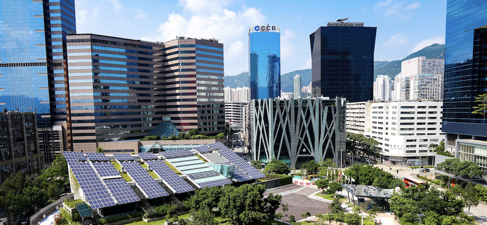 Solar panels in park surrounded by skyscrapers