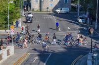 Cyclists and pedestrians on a street in Dublin.