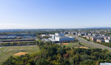 Aerial view of a large data center campus near homes and a playfield.