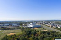 Aerial view of a large data center campus near homes and a playfield.