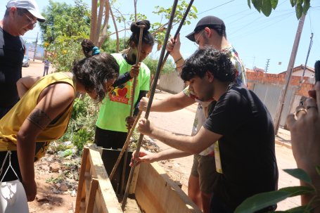 People working in a planter box. 