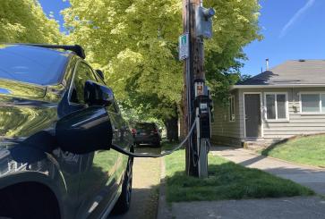 Electric vehicle charging at pole-mounted charging station