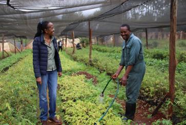 Caroline Kariuki, CEO of Kenya's GreenPot Enterprises, with one of her employees at a bamboo nursery. The company's bamboo helps farmers restore degraded land and make extra income.