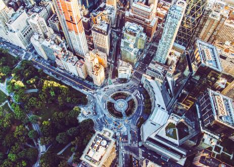 Ariel shot of a city with lots of trees.
