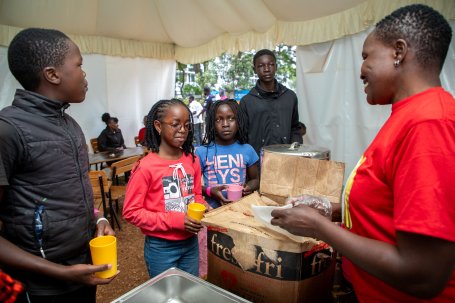 Students lineup to get free meals provided by the library.