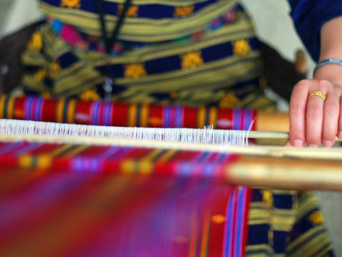 Woman weaving beautiful textile 