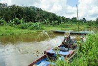 Journalist on field trip on river.