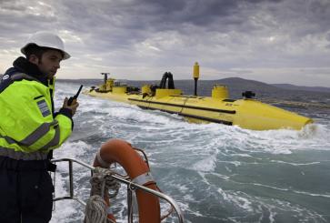 Man wearing reflective gear using walkie talkie on ocean