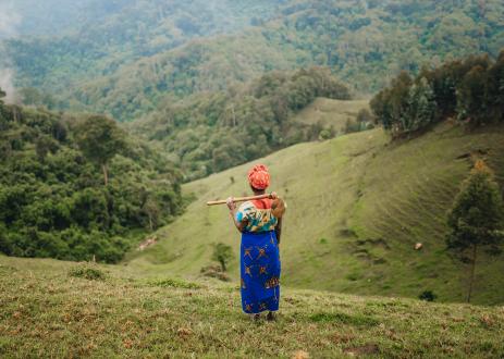 Local Woman Standing in the fields and looking in the forest
