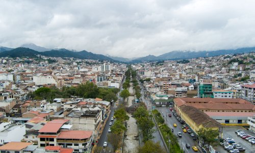 A view of Loja, Ecuador shows streets, homes and a river running through the city.