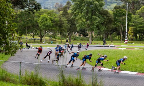 A group of people rollerblade on a pathway in Loja, Ecuador.