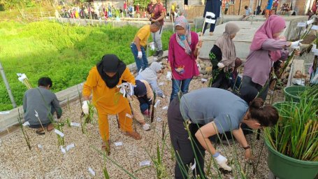 Community members help with planting of a wetland area.