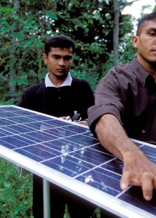 Men carrying solar panel
