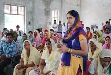 Woman standing and speaking in group