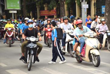 Motorcyclists and pedestrians in Ho Chi Minh City, Vietnam