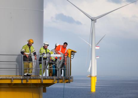 Workers on an offshore wind turbine tower.