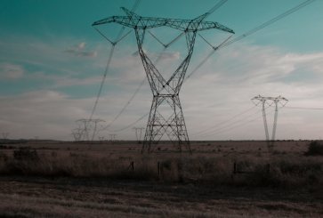 A field with power lines in the distance.