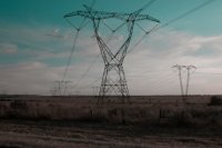 A field with power lines in the distance.