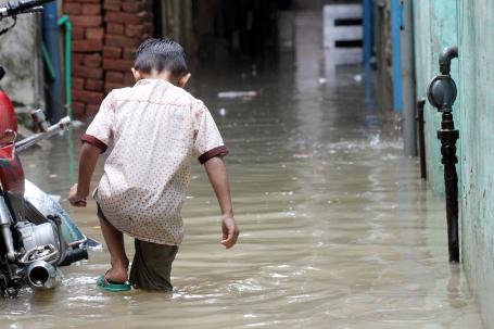 A child wades through flood waters in Pakistan.