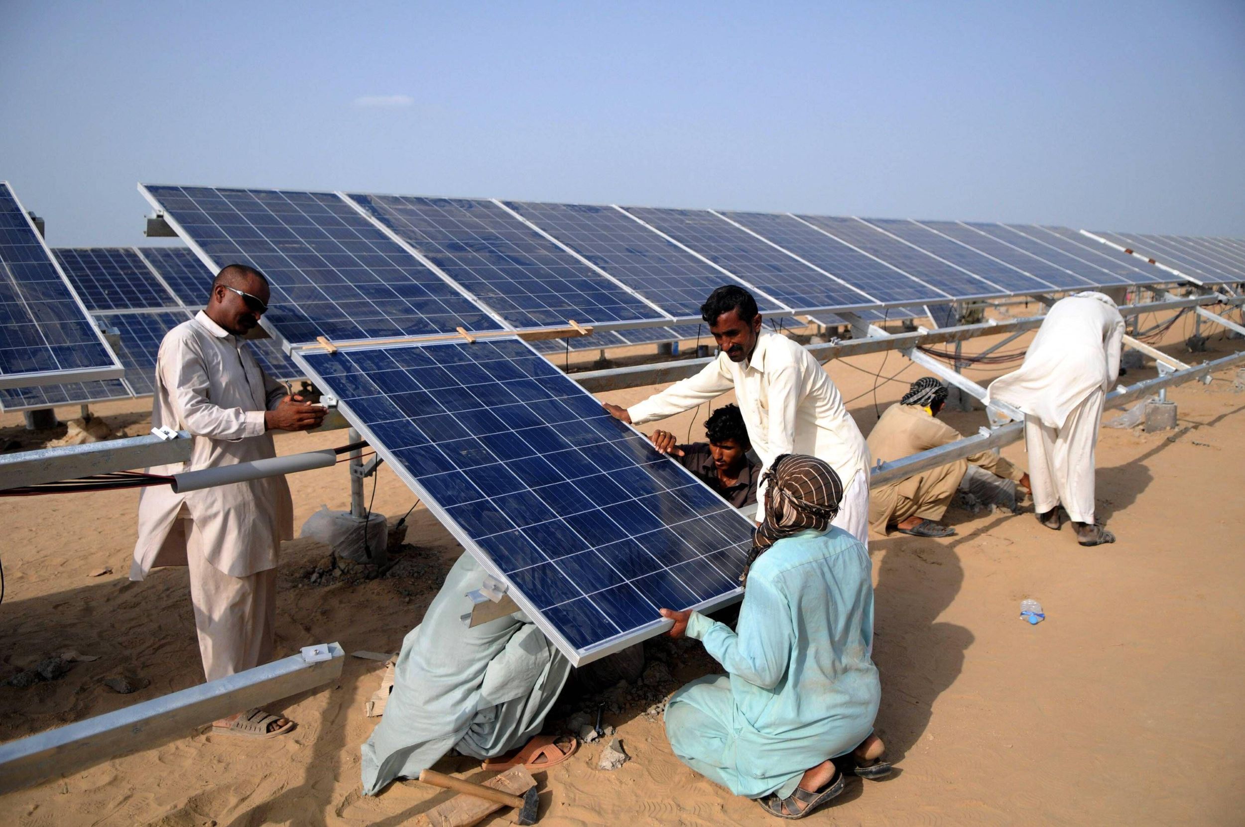 Installing solar panels in Pakistan.