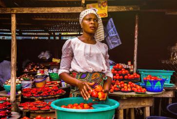 woman holding tomatoes