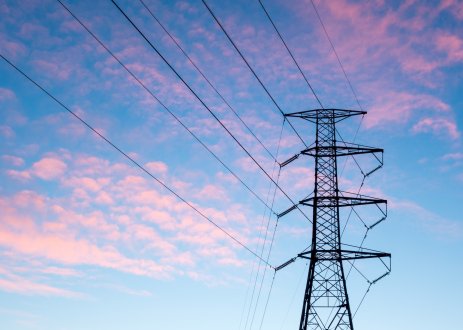 Power line against sky with pink clouds.
