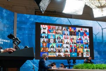 President Joe Biden speaking at a podium to the virtual Climate Leaders Summit