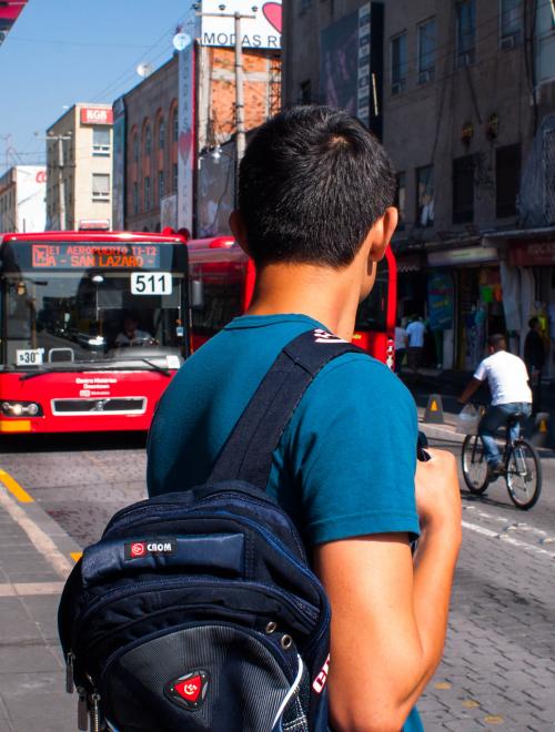 Isaac waits for an approaching bus operating on Line 4. Both Isaac and Salomón agree that the generous dispersion of bus stops throughout the Historic Center facilitate easy transport of purchased goods, encouraging more people to come shop in the area. Photo by Taís Policanti.