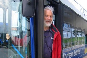 Photo of Lee Schipper, co-founder of EMBARQ, standing in a bus doorway