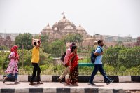 Group of people walking on road during heat wave in New Delhi