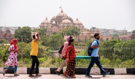 Group of people walking on road during heat wave in New Delhi