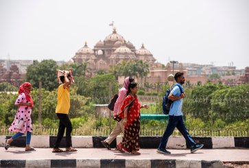 Group of people walking on road during heat wave in New Delhi