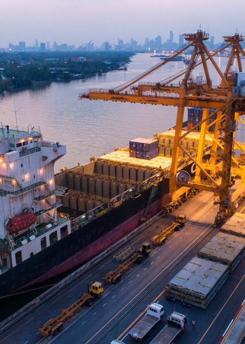 Shipping scene on a river looking over a large city.