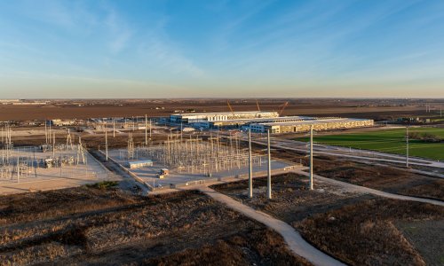 Aerial view of a large data center campus with power generation on site.