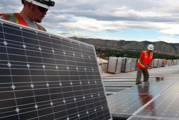 two men installing solar panels