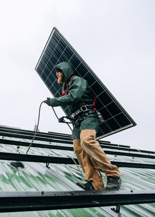 Technicians installing solar panels.